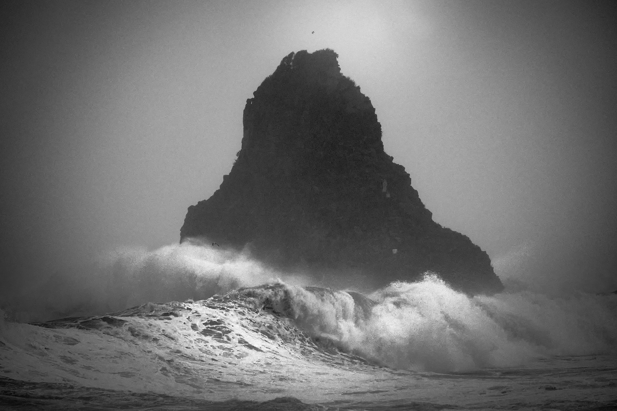 Powerful storm waves beneath the Faraglioni of Aci Trezza during Cyclone Henry