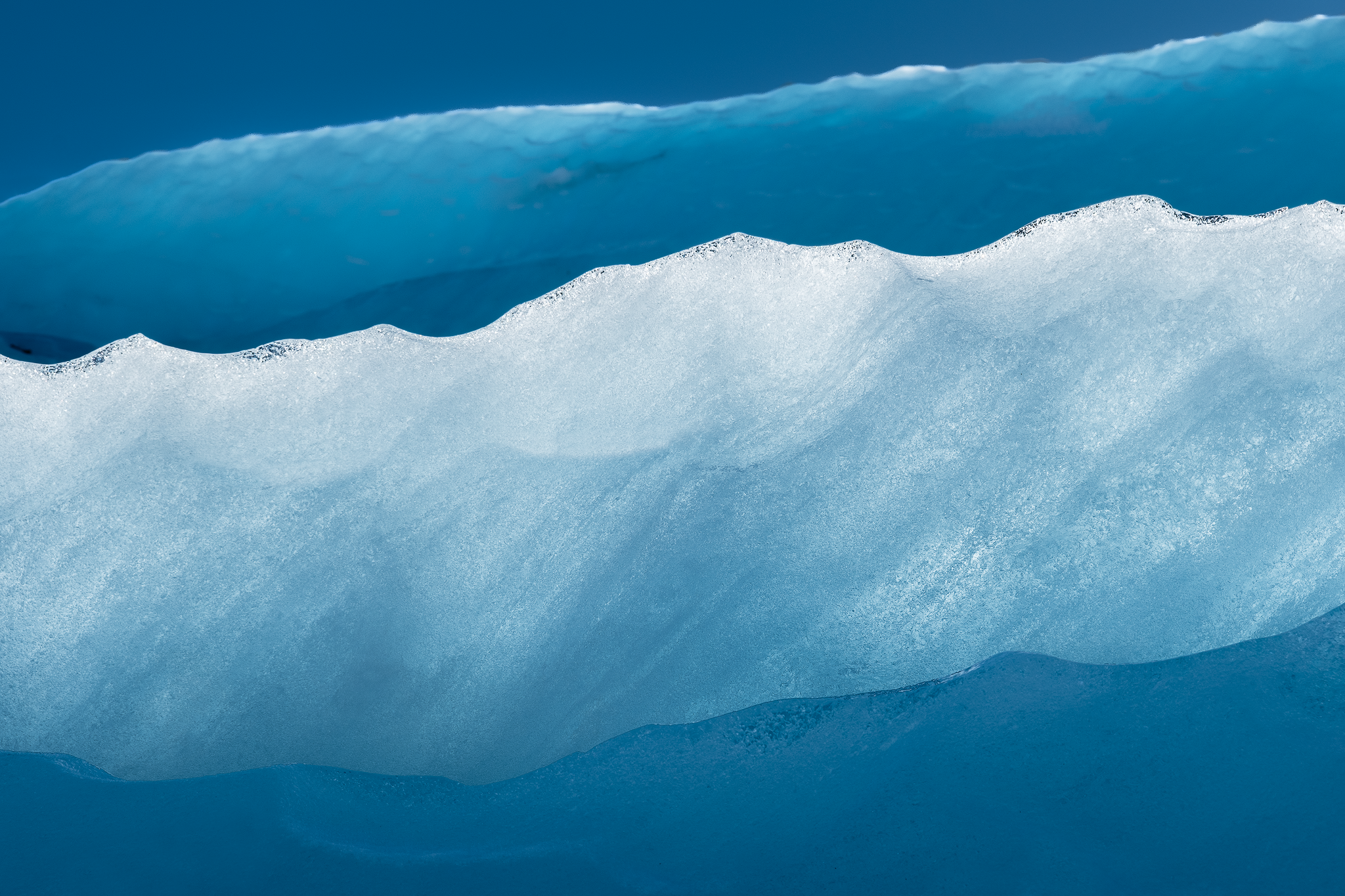 Minimal abstract composition of layered blue and white glacial ice in Iceland